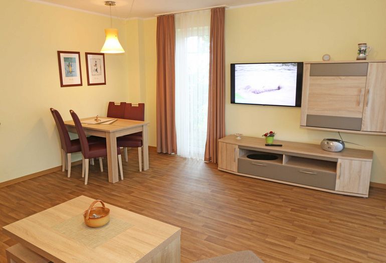 Wohnzimmer mit TV und Esstisch