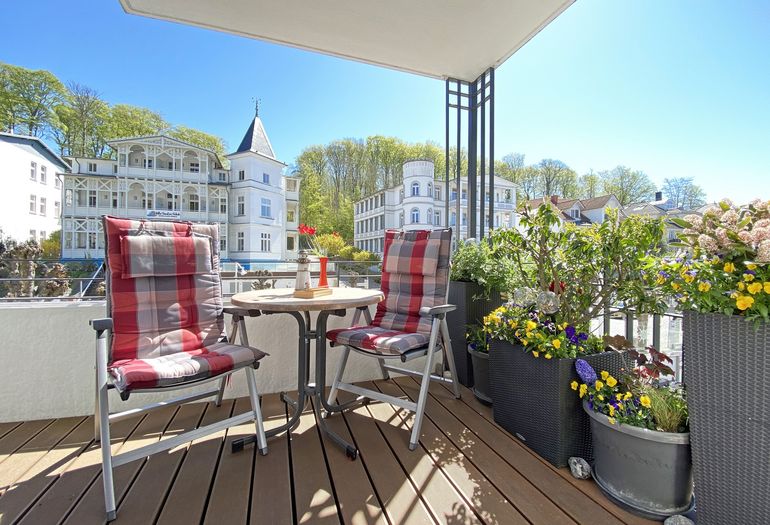 bestuhlter Balkon mit viel Grün