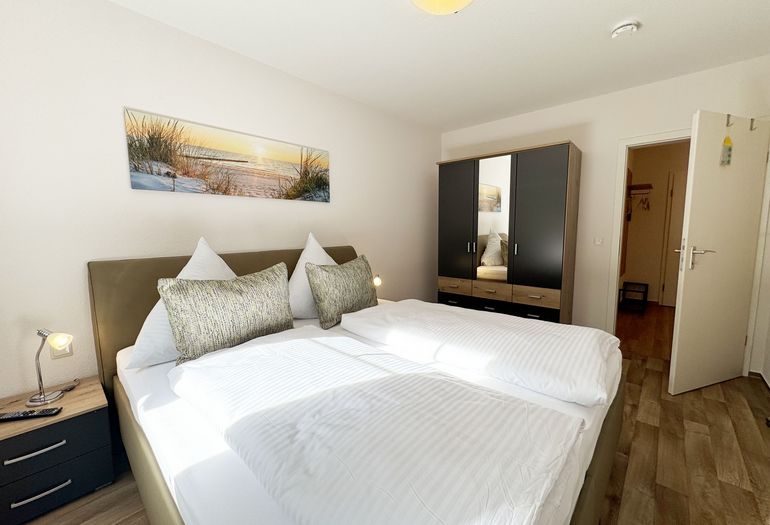 Schlafzimmer mit Doppelbett und Nachttischablagen