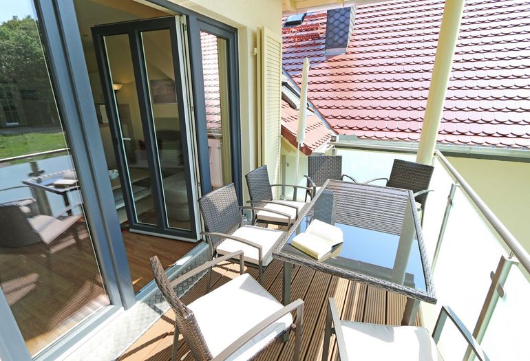 bestuhlter Balkon mit Blick ins grüne