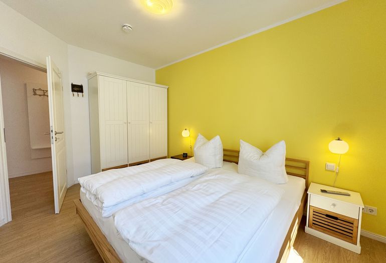 Schlafzimmer mit Doppelbett und Kleiderschrank