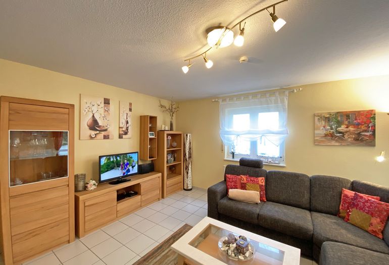 Wohnzimmer mit TV und großer Couch