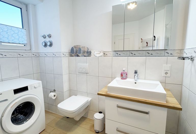 Badezimmer mit WC und Waschmaschine