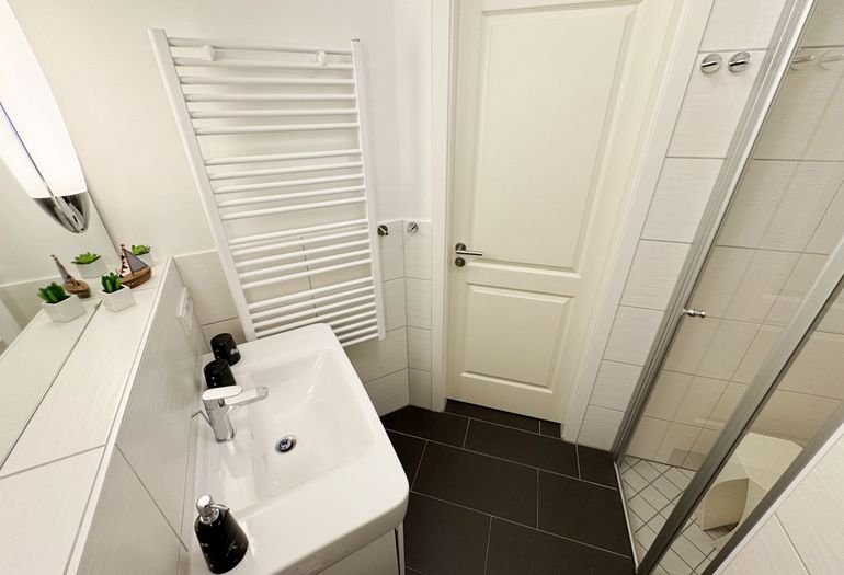 Badezimmer mit Waschbecken und Dusche Badezimmer mit Waschbecken und Dusche