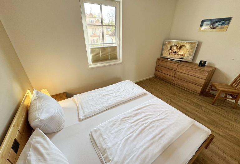 1. Schlafzimmer mit Doppelbett und TV