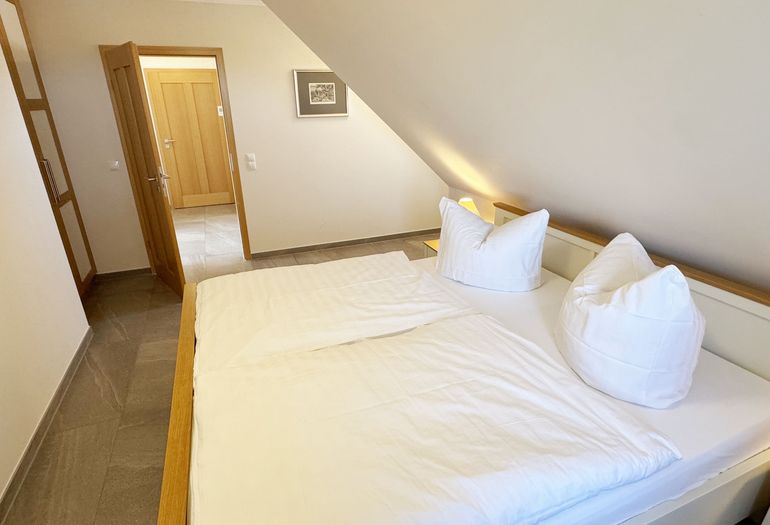 Schlafbereich mit Doppelbett und Kleiderschrank